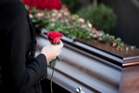 woman-at-funeral-with-coffin.jpg